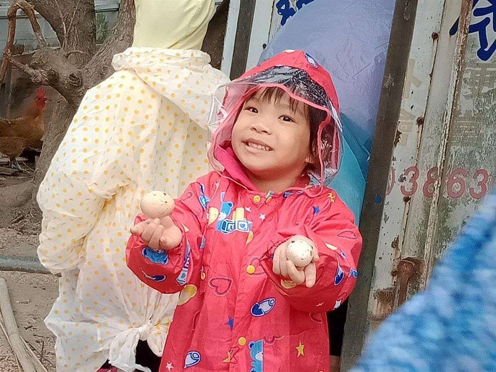 孩子開心的展示自己撿起的生雞蛋。